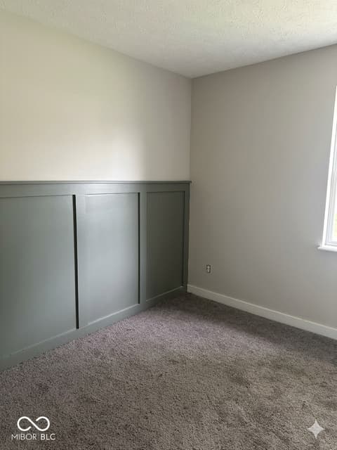 Bedroom at 6815 Cherry Laurel Lane, Fishers, IN — Spacious bedroom with classic wainscoting details.