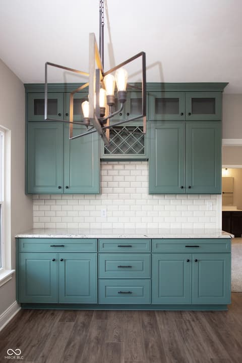 Kitchen at 13562 Creekridge Lane, Fishers, IN — Stunning teal kitchen with subway tile and modern lighting.