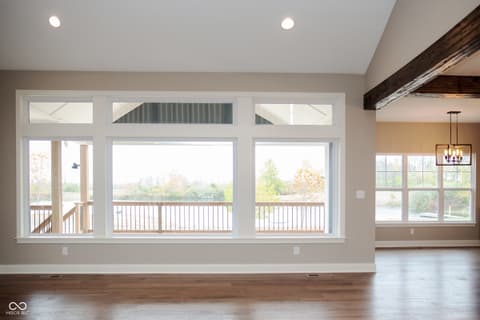 Living room at 13562 Creekridge Lane, Fishers, IN — Bright living room with water views and deck access.
