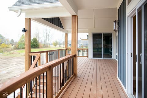 Outdoor living area at 13562 Creekridge Lane, Fishers, IN — Spacious covered deck with composite flooring and views.