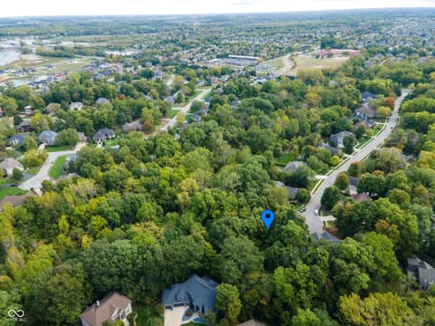Aerial view at 13562 Creekridge Lane, Fishers, IN — Secluded home on heavily wooded lot with river views.
