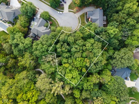 Aerial view at 13562 Creekridge Lane, Fishers, IN — Private wooded lot in established residential neighborhood.