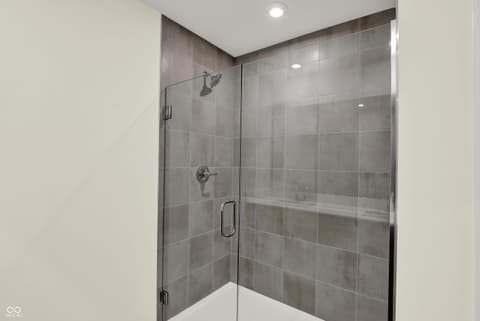 Primary bathroom at 3944 E 191st Street, Westfield, IN — Luxurious frameless walk-in shower with rainfall head.