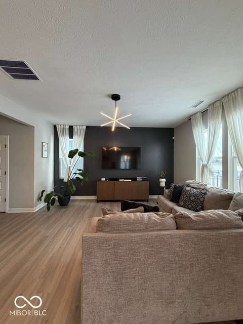 Living room at 19994 Edwick Drive, Westfield, IN — Modern living room with accent wall and smart lighting.