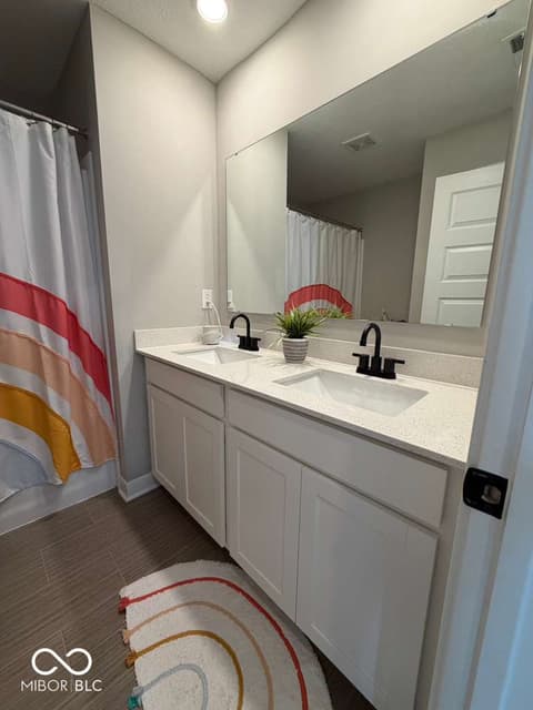 Primary bathroom at 19994 Edwick Drive, Westfield, IN — Stunning primary bath with dual vanity and quartz counters.
