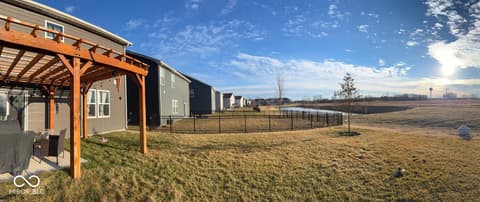 Backyard at 19994 Edwick Drive, Westfield, IN — Modern farmhouse with pergola on expansive rural acreage.
