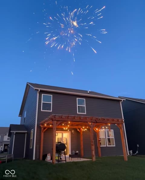 Backyard at 19994 Edwick Drive, Westfield, IN — Modern home with charming lit pergola and spacious patio.