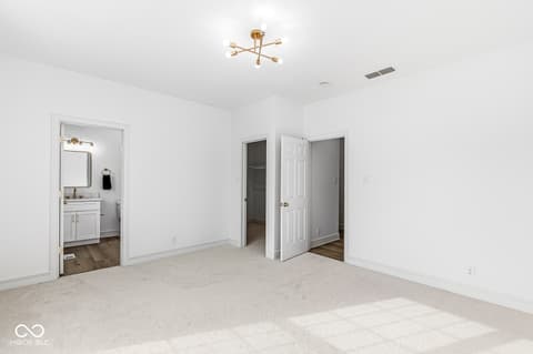 Primary bedroom at 10380 Spring Highland Drive, Indianapolis, IN — Spacious primary bedroom with ensuite bathroom access.