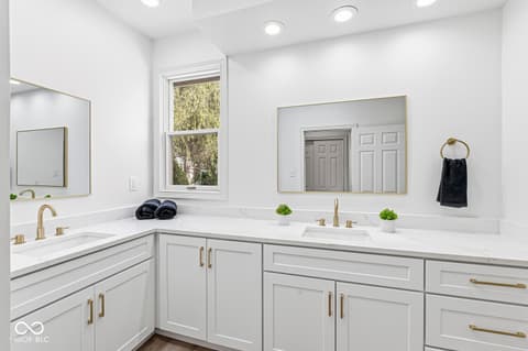 Primary bathroom at 10380 Spring Highland Drive, Indianapolis, IN — Luxurious spa-like primary bath with dual vanity.