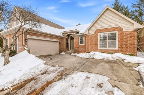 Front exterior at 10380 Spring Highland Drive, Indianapolis, IN — Well-maintained brick ranch with mature landscaping.