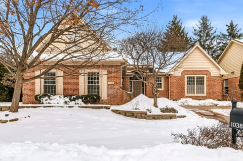 Front exterior at 10380 Spring Highland Drive, Indianapolis, IN — Charming brick home with mature trees and curb appeal.