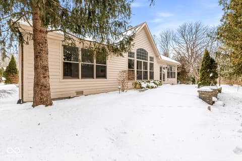 Backyard at 10380 Spring Highland Drive, Indianapolis, IN — Modern home with abundant windows and mature landscaping.