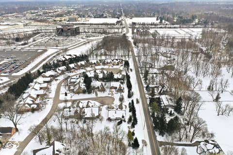 Aerial view at 10380 Spring Highland Drive, Indianapolis, IN — Established suburban community with large wooded lots.