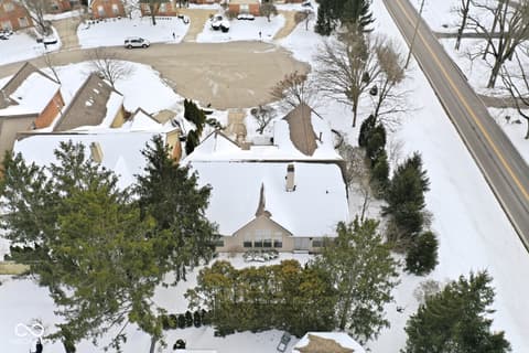 Aerial view at 10380 Spring Highland Drive, Indianapolis, IN — Charming traditional home on spacious snowy lot.