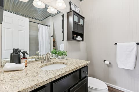 Primary bathroom at 38 Homestead Drive, Sheridan, IN — Beautifully renovated primary bath with granite countertops.