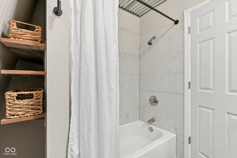 Primary bathroom at 38 Homestead Drive, Sheridan, IN — Spa-like primary bath with marble tile and modern fixtures.