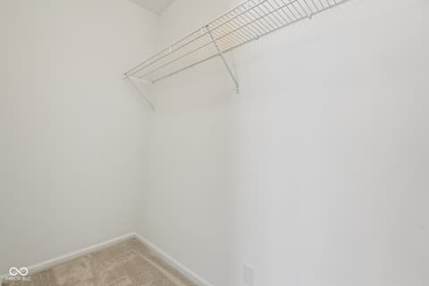 Bedroom at 38 Homestead Drive, Sheridan, IN — Spacious walk-in closet with organized shelving storage.