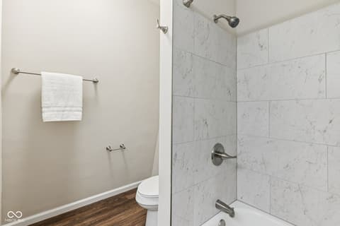 Primary bathroom at 38 Homestead Drive, Sheridan, IN — Marble shower with glass door and dual showerheads.