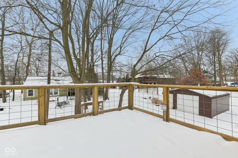 Outdoor living area at 38 Homestead Drive, Sheridan, IN — Modern deck with cable railing and wooded views.
