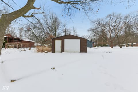 Backyard at 38 Homestead Drive, Sheridan, IN — Spacious wooded property with detached garage and deck.