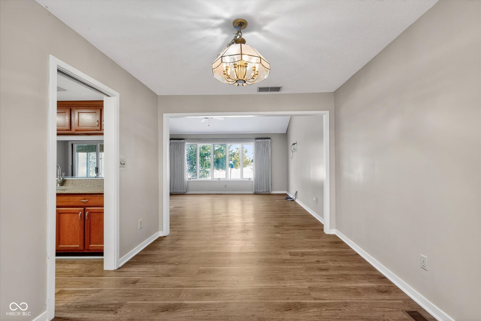 Bright open living area with hardwood floors and abundant natural light.