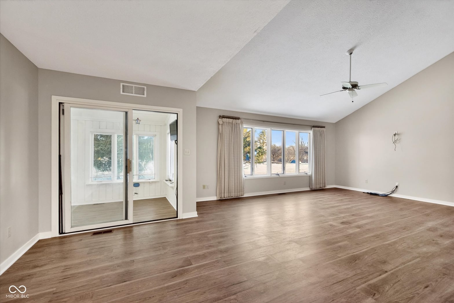 Spacious primary suite with abundant natural light and hardwood floors.