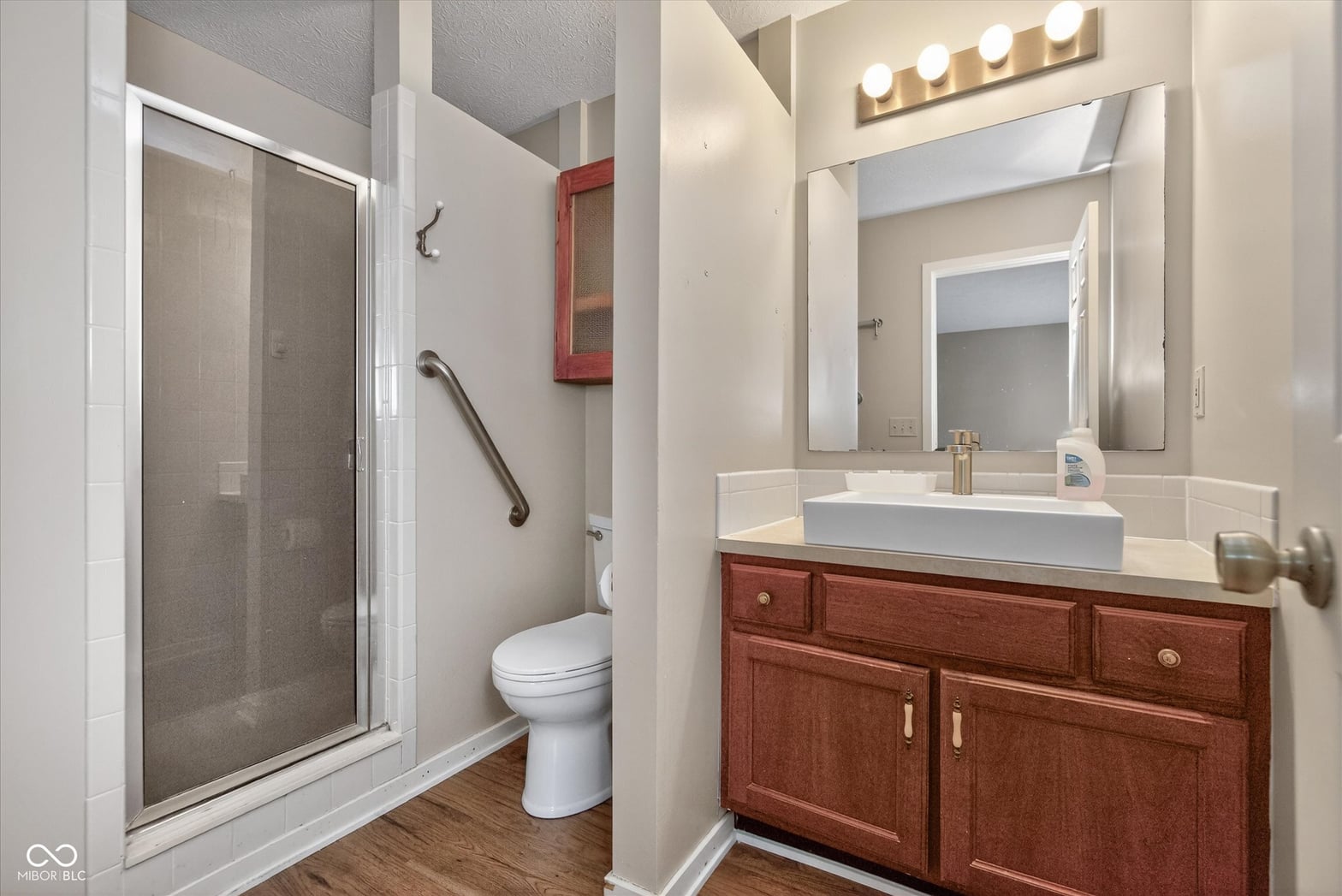 Spacious primary bath with modern vessel sink and updated shower.