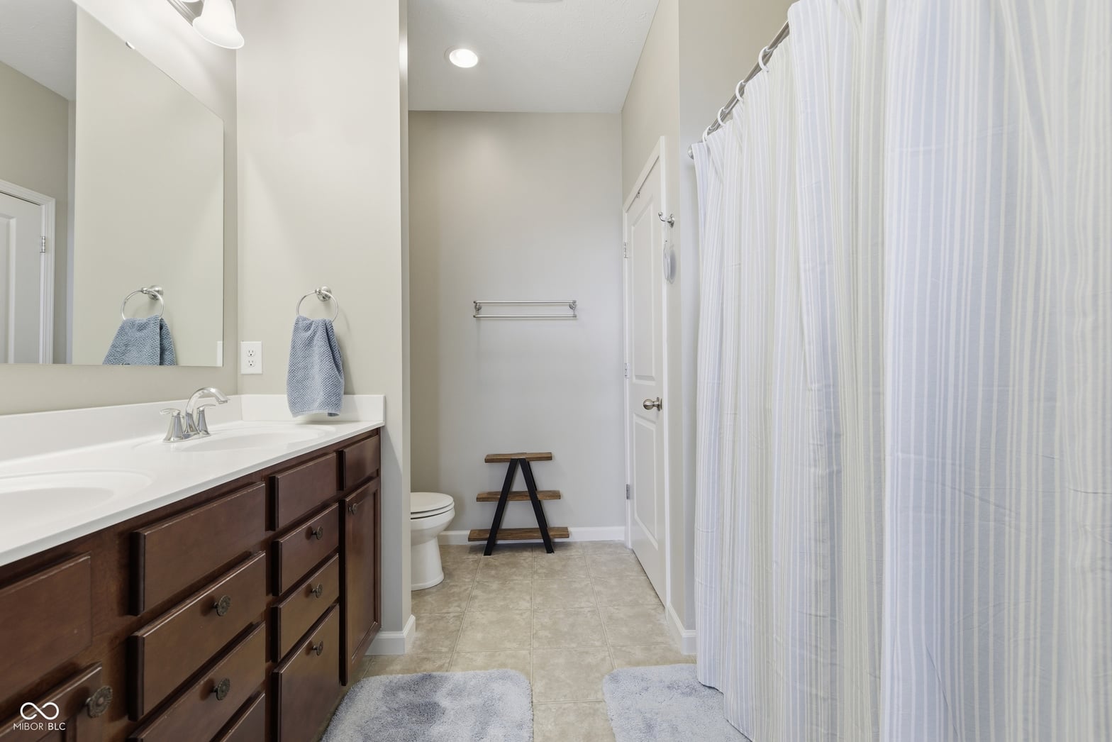 Spacious dual vanity primary bath with modern finishes.
