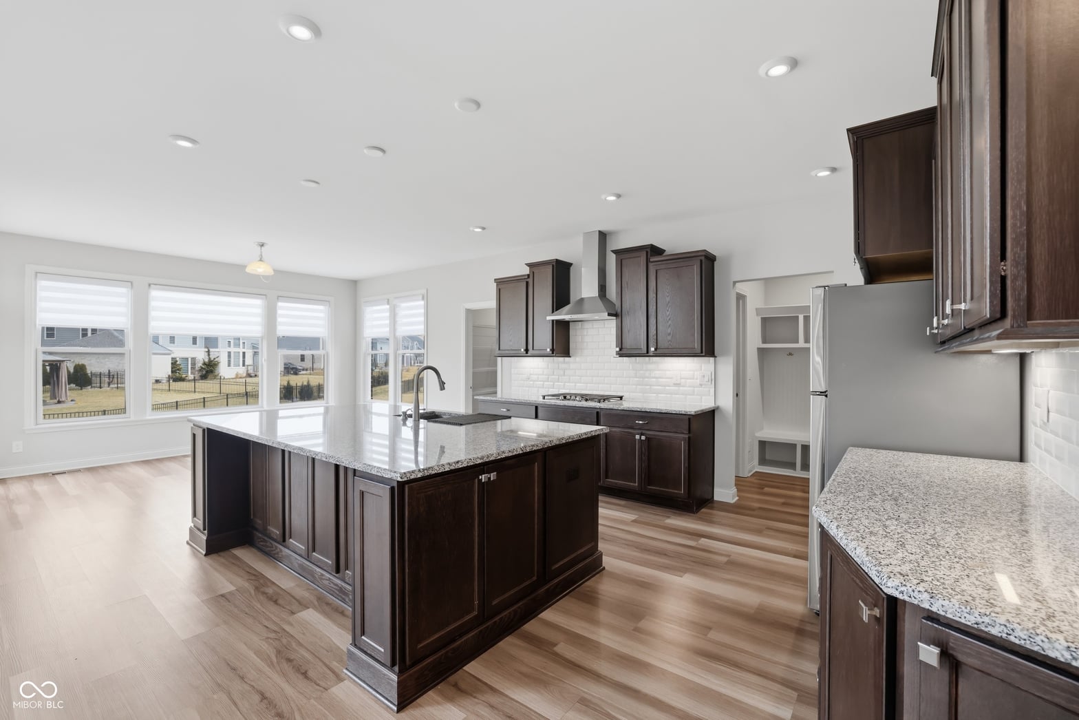 Bright modern kitchen with granite island and abundant natural light.