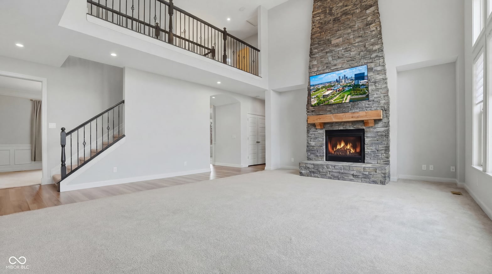 Stunning two-story family room with modern gas fireplace.