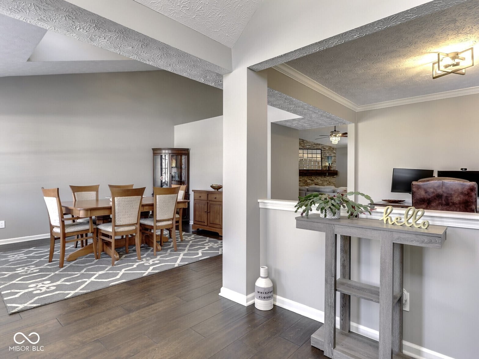 Open concept living with architectural ceiling beams.