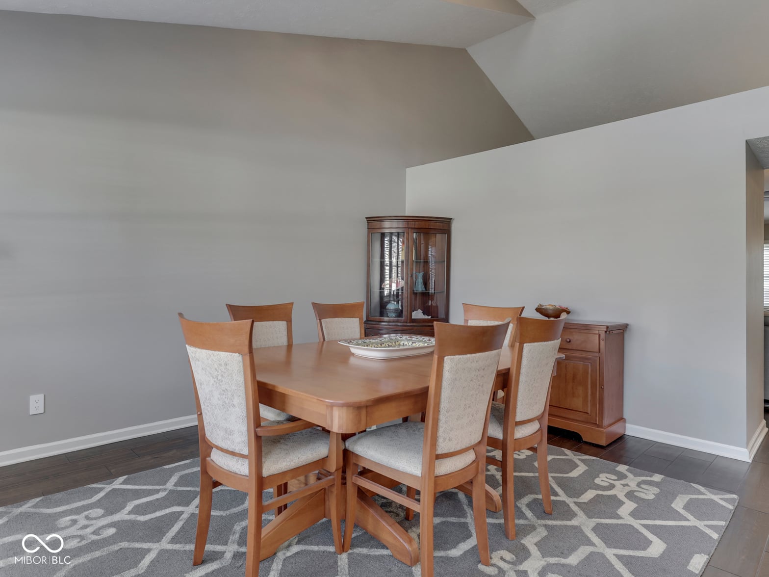 Spacious dining room with vaulted ceilings and hardwood floors.