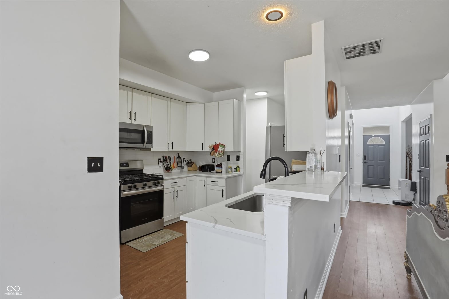 Bright updated kitchen with white cabinets and quartz island.