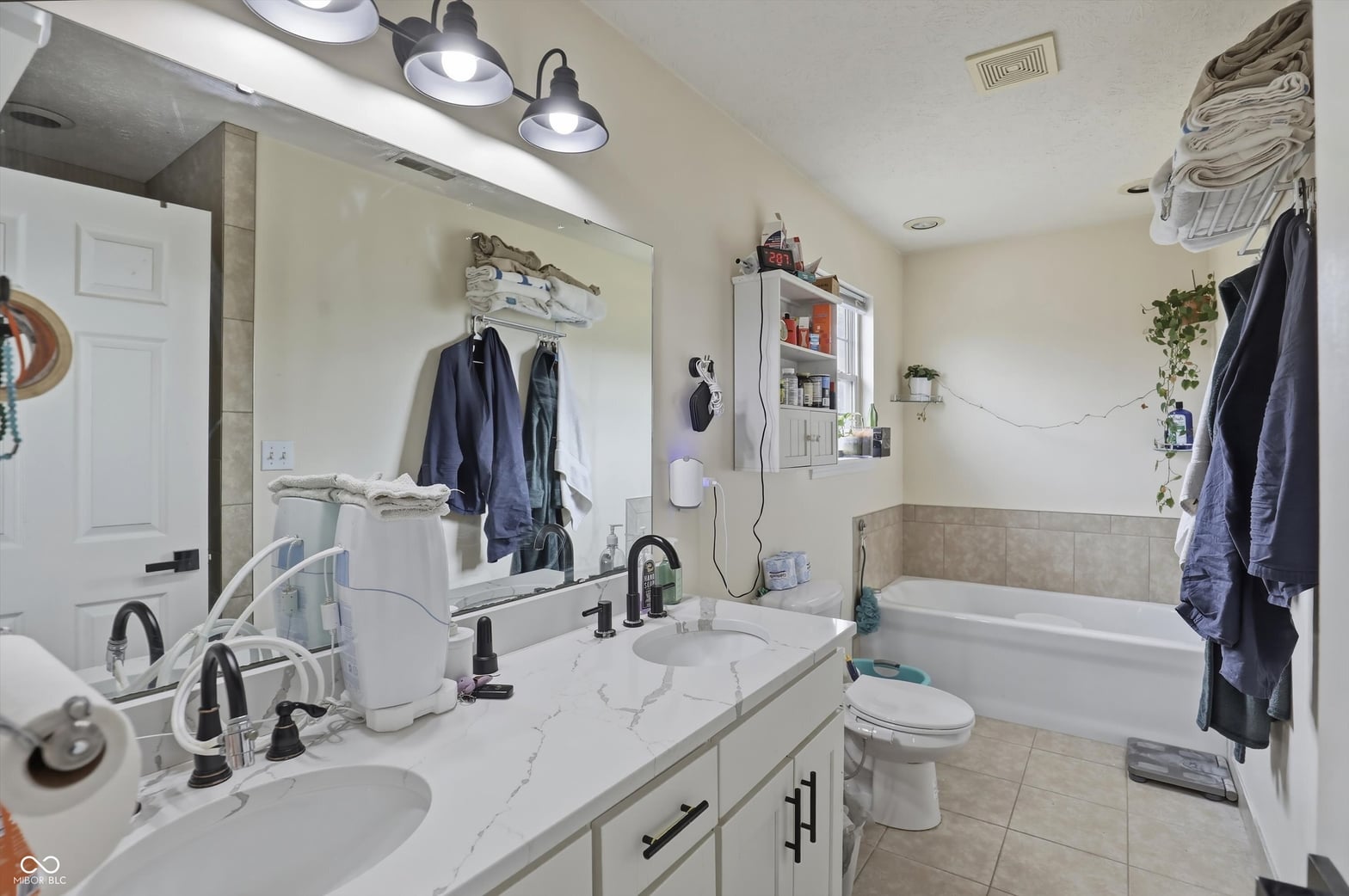 Spacious primary bath with double vanity and soaking tub.