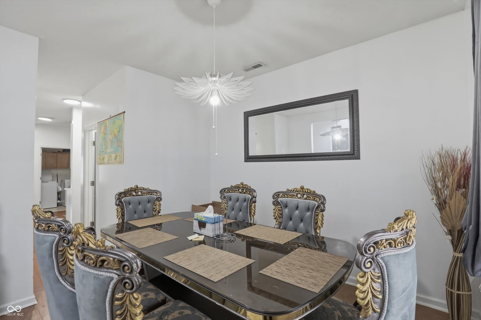 Elegant dining room with ornate furniture and modern fixtures.