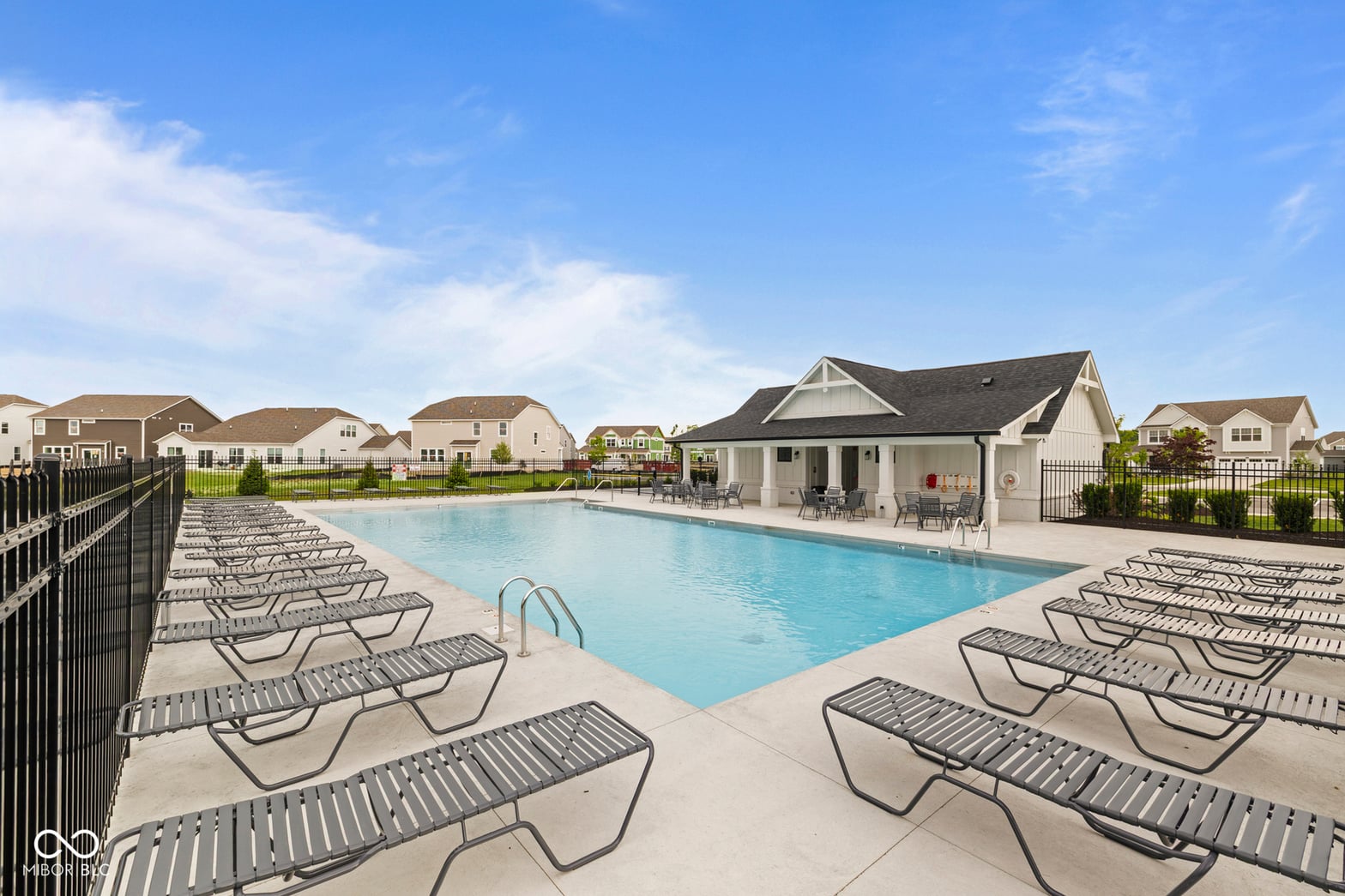 Modern community pool with resort-style lounge area.