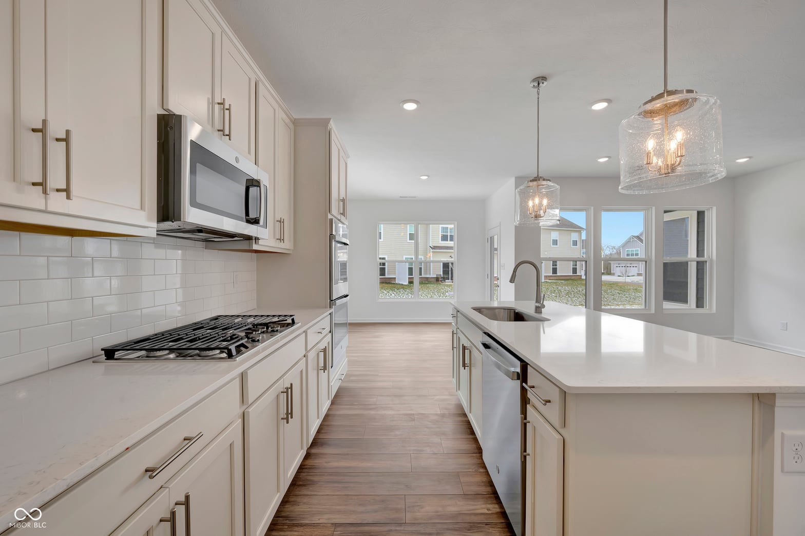 Bright, modern kitchen with white cabinetry and island.