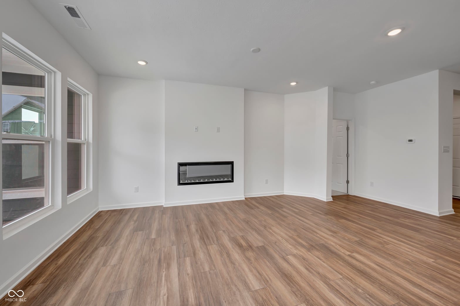 Modern living room with sleek linear fireplace and hardwoods.