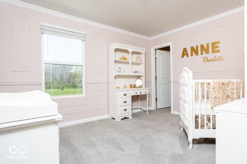 Primary bedroom at 5300 Veranda Drive, Noblesville, IN — Luxurious nursery with shiplap walls and built-in storage.