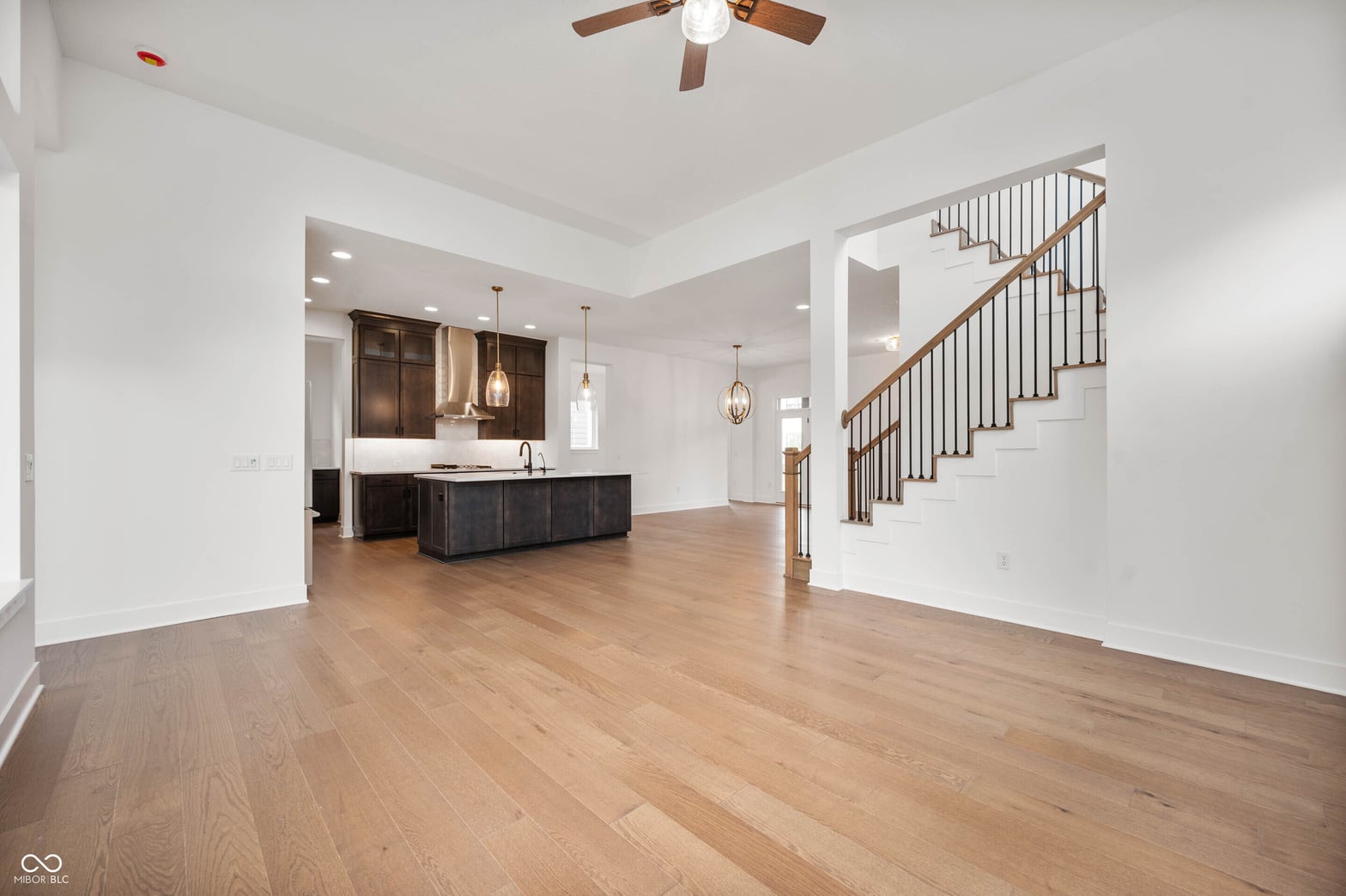 Bright open-concept living space with premium hardwood flooring.