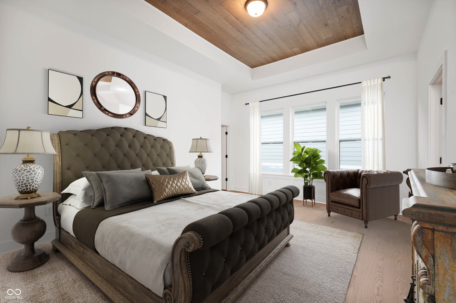 Luxurious primary suite with elegant tufted bed and seating area.