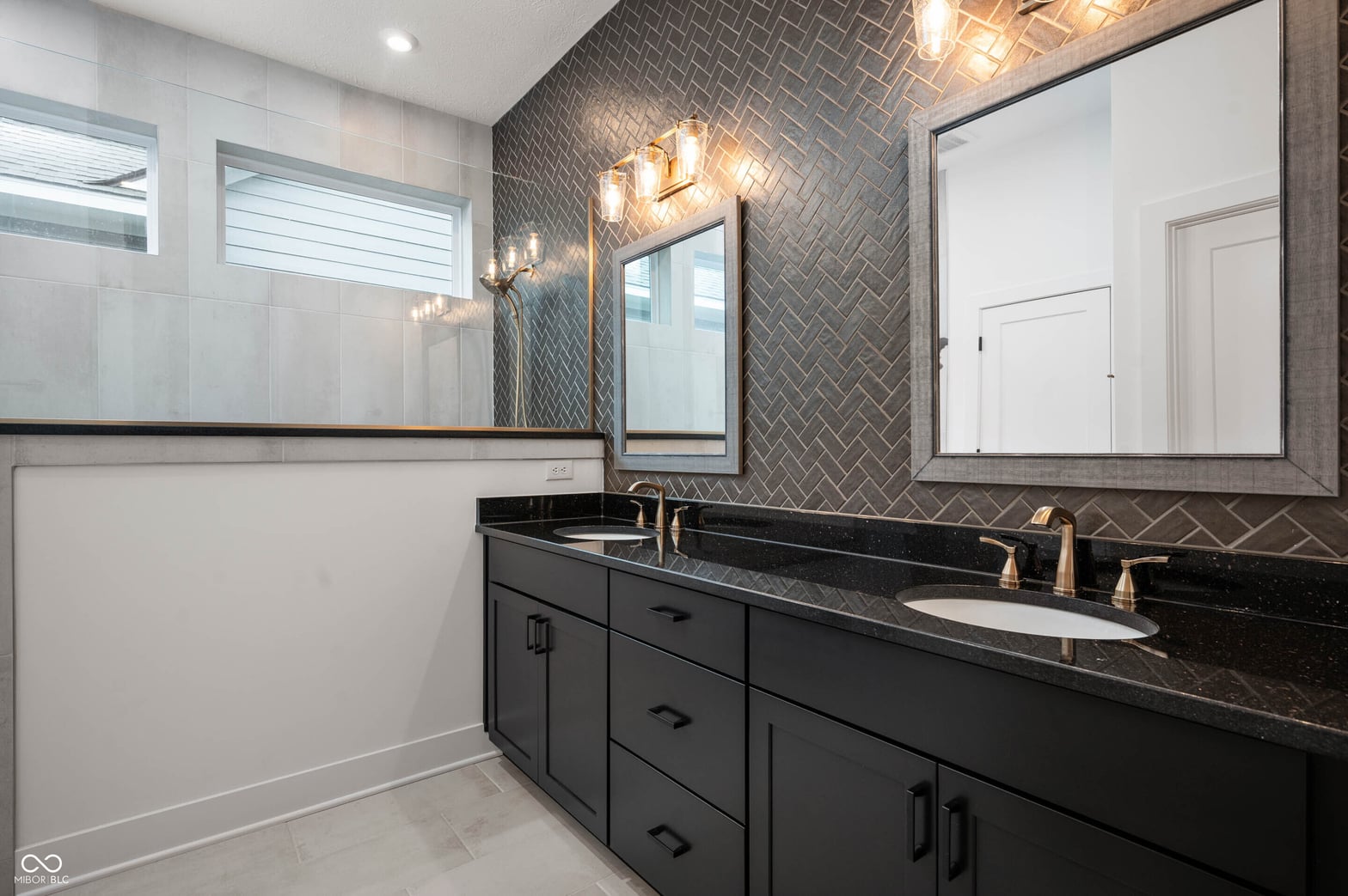 Luxurious primary bath with double vanity and designer finishes.
