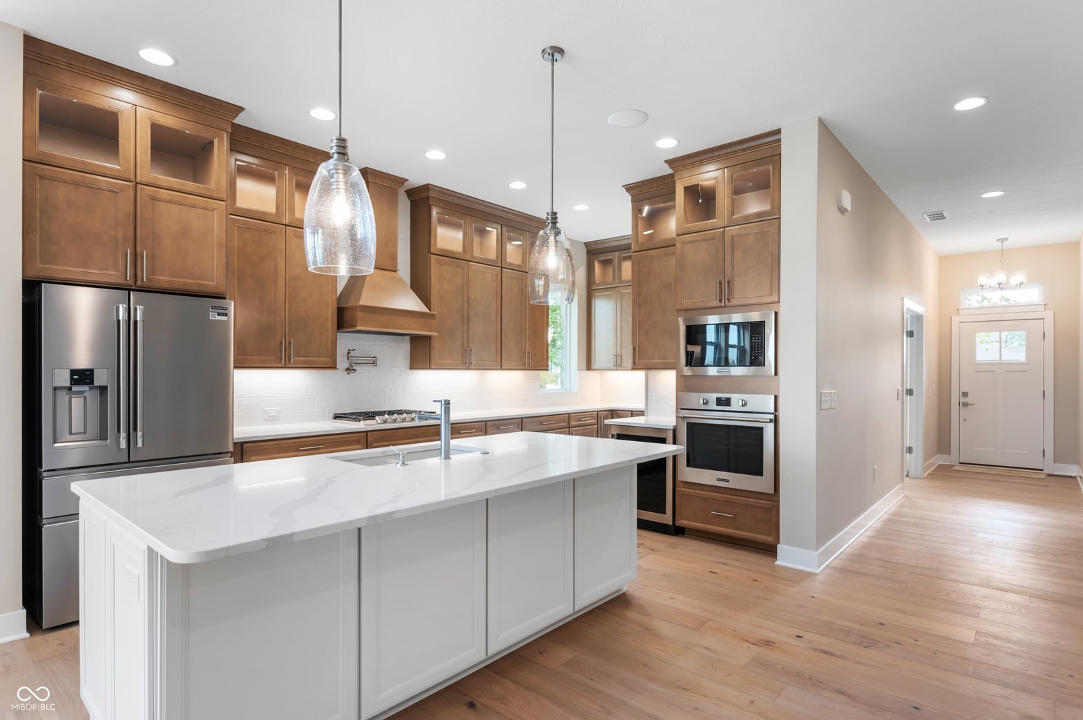 Bright updated kitchen with white island and premium appliances.