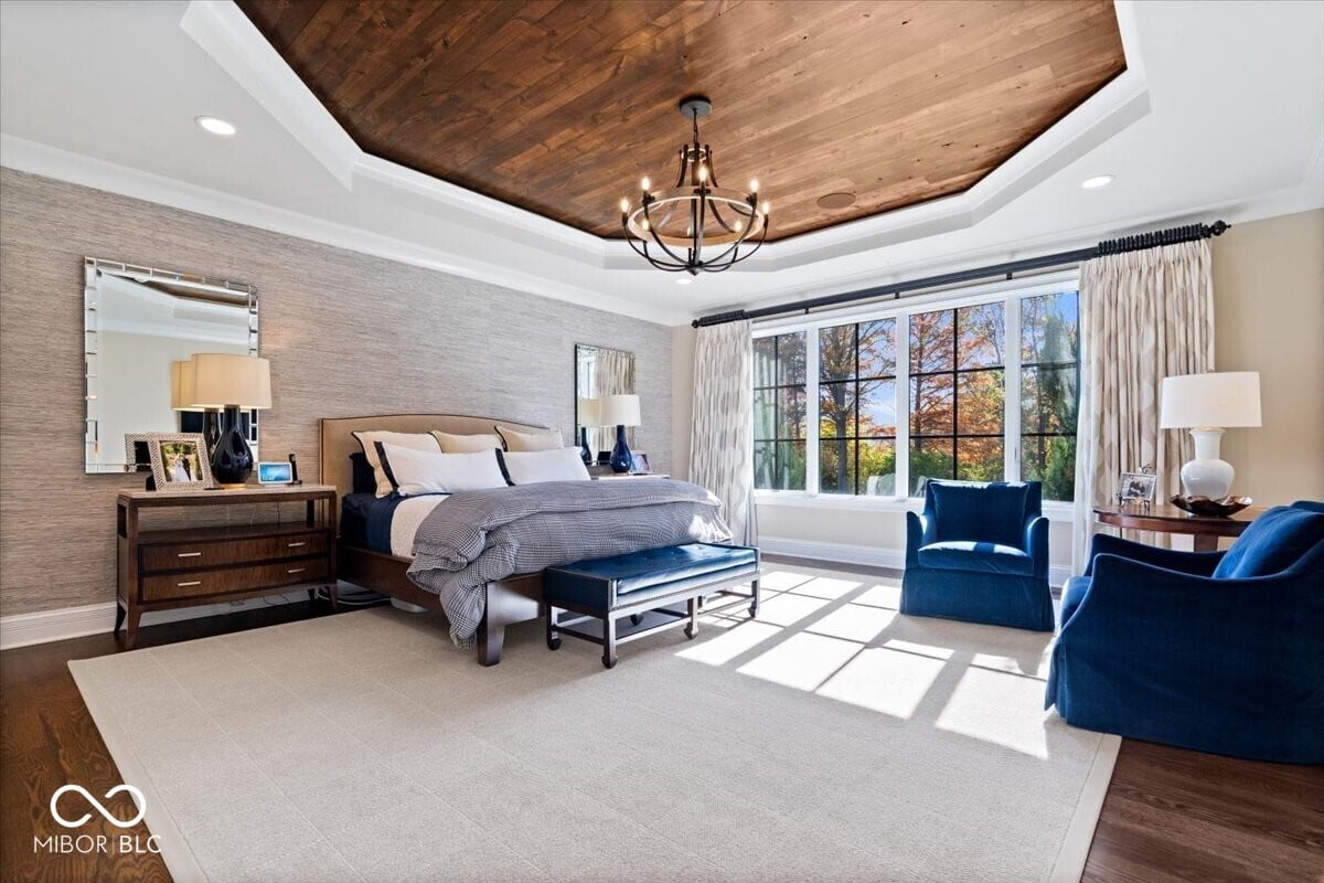 Luxurious primary suite with soaring wood ceiling and views.
