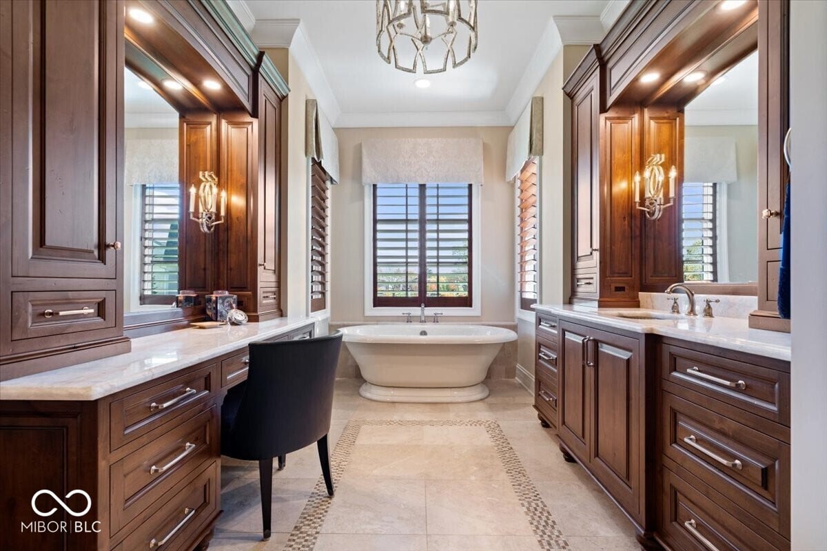 Luxurious primary bath with dual vanities and soaking tub.