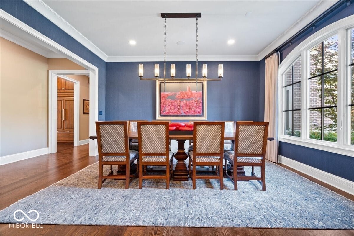 Elegant dining room with coffered ceiling and natural light.