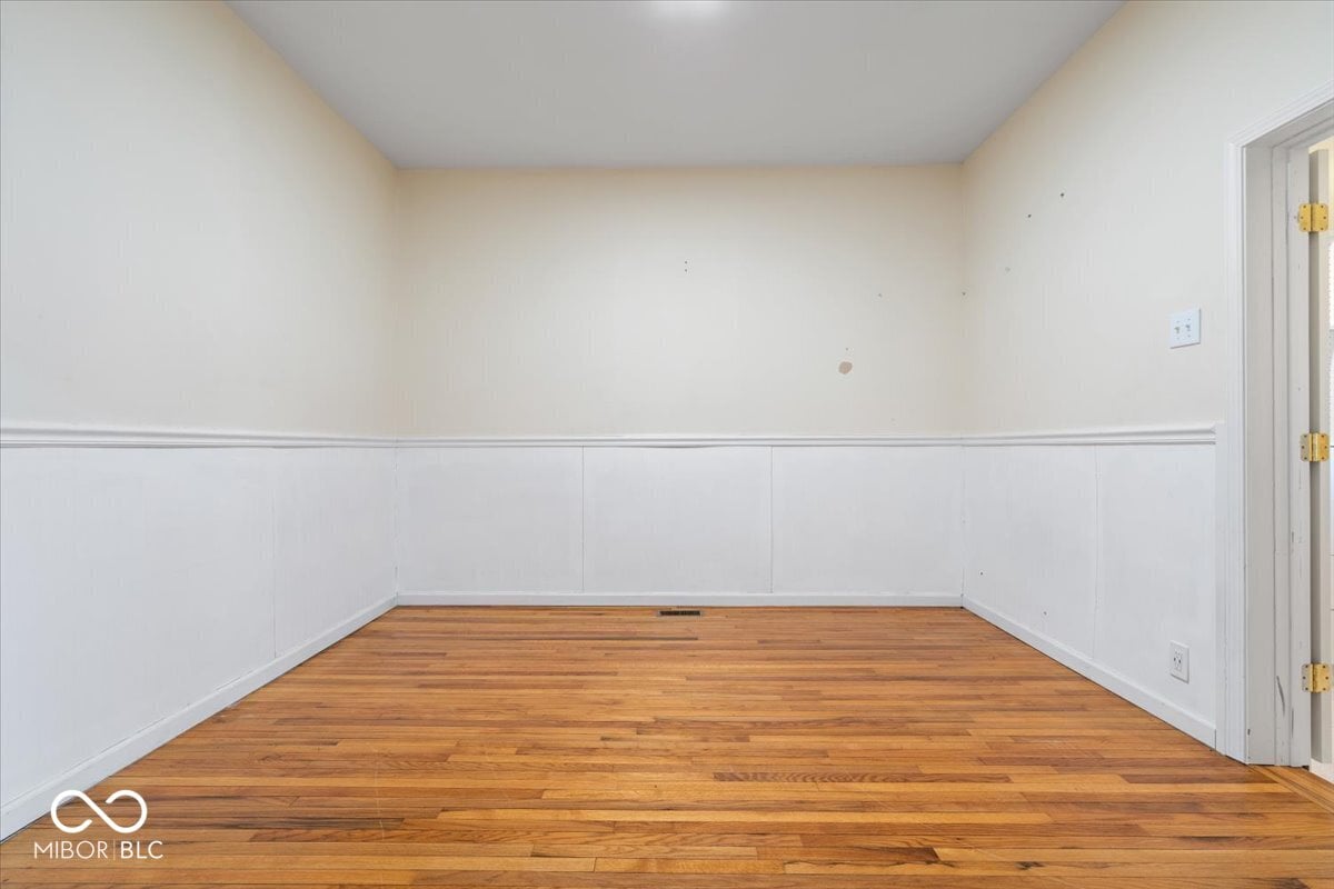 Classic dining room with original hardwood floors and wainscoting.