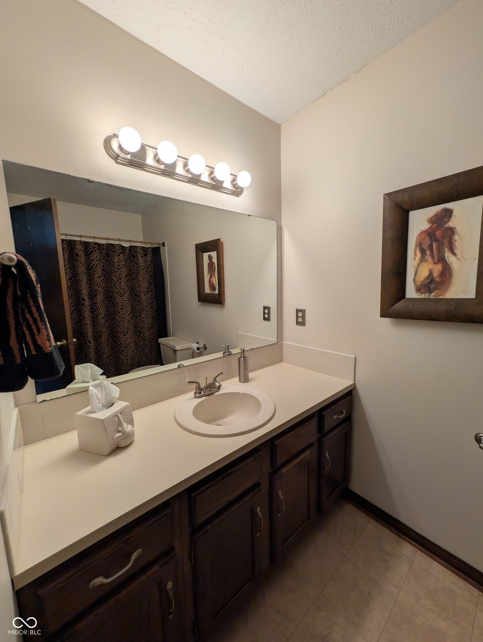 Spacious primary bath with updated vanity and modern fixtures.