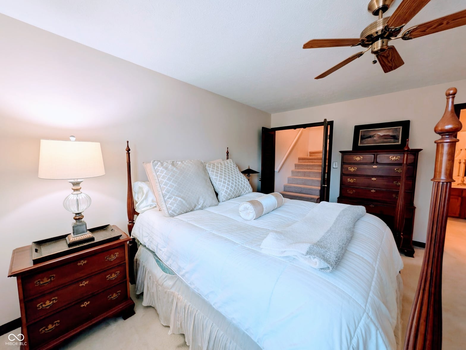 Spacious primary bedroom with ensuite access and traditional furnishings.