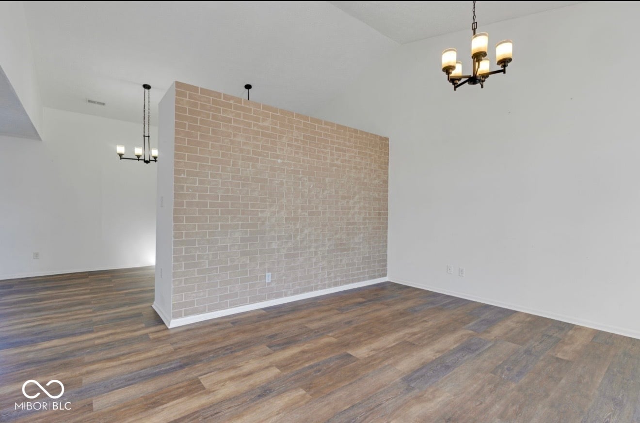 Modern living space with striking brick fireplace accent.